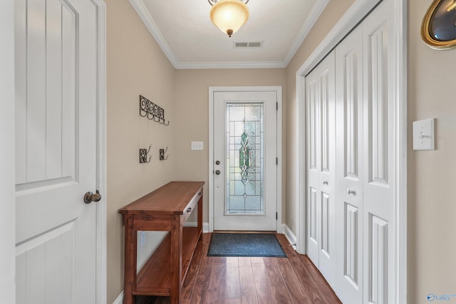 doorway to outside with a textured ceiling, dark hardwood / wood-style floors, and crown molding