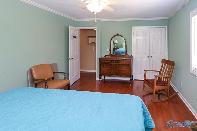 bedroom with dark wood-type flooring, crown molding, a closet, and ceiling fan