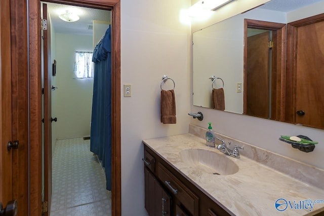 bathroom with vanity and a textured ceiling