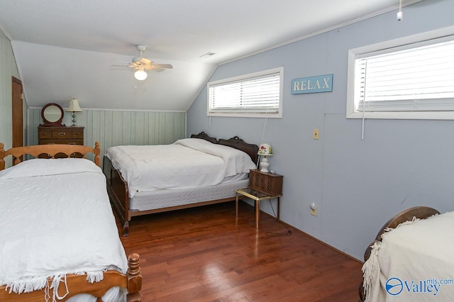 bedroom with vaulted ceiling, visible vents, ceiling fan, and wood finished floors