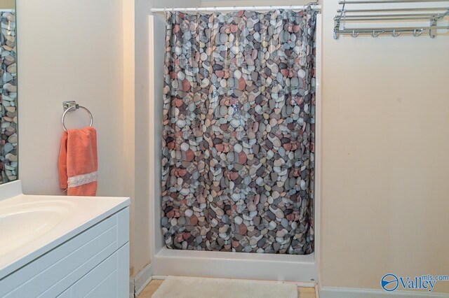 bathroom featuring vanity and a shower with shower curtain