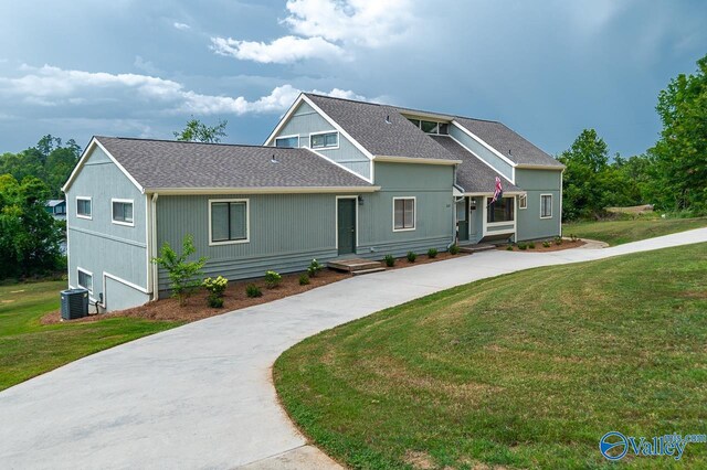 front of property with a front yard and cooling unit