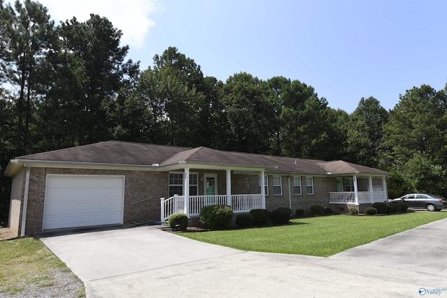 ranch-style home featuring a porch, a garage, and a front yard