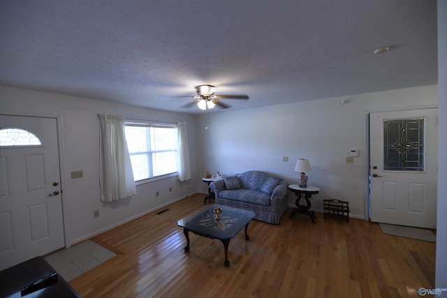 living room with hardwood / wood-style floors and ceiling fan