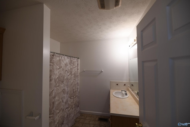 bathroom with vanity and a textured ceiling