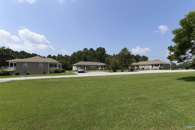 ranch-style home featuring a front yard