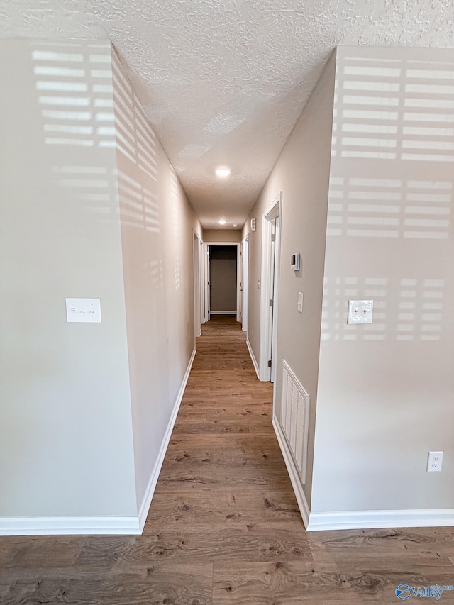 918 Wilson Ave, Gadsden, AL 35903 - hallway with wood finished floors, baseboards, and a textured ceiling