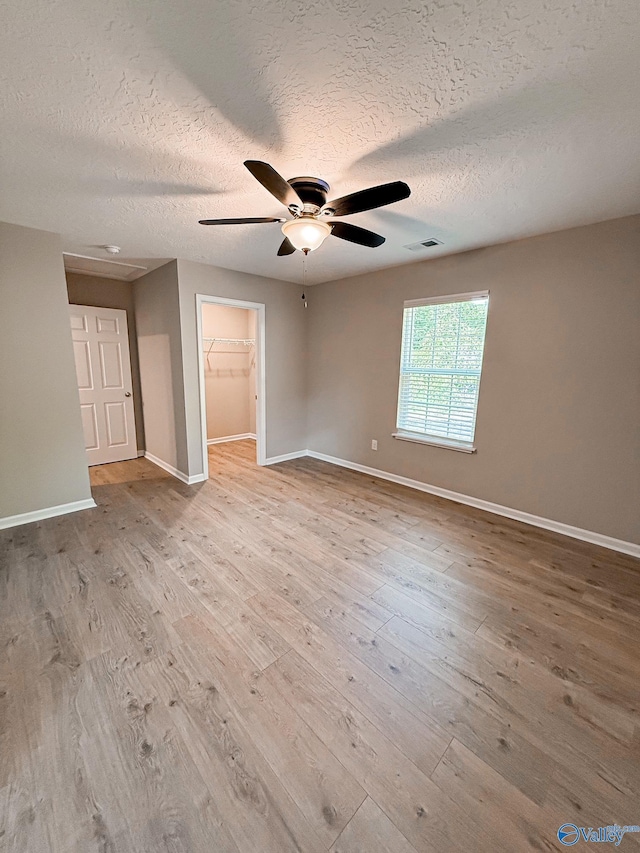 918 Wilson Ave, Gadsden, AL 35903 - spare room featuring a textured ceiling, baseboards, ceiling fan, and wood finished floors