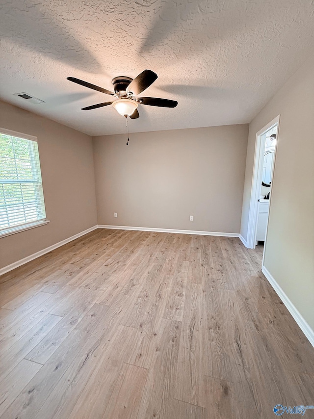 918 Wilson Ave, Gadsden, AL 35903 - spare room featuring a textured ceiling, light wood-type flooring, a ceiling fan, and baseboards