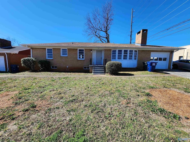 ranch-style home with a garage and a front lawn