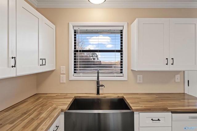 615 County Road 40, Centre, AL 35960 - kitchen with wood counters, ornamental molding, a sink, and white cabinets