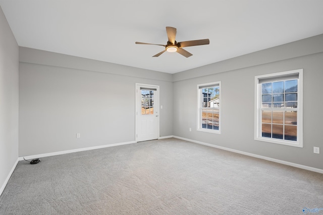 carpeted empty room featuring ceiling fan