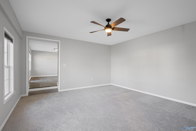 empty room with carpet flooring and ceiling fan