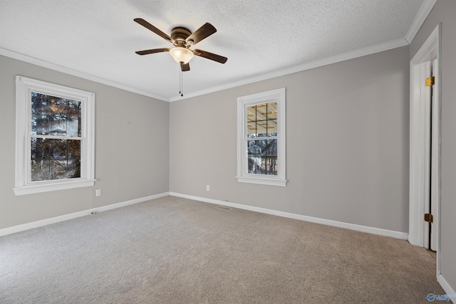 unfurnished room featuring ornamental molding, carpet, a textured ceiling, and ceiling fan