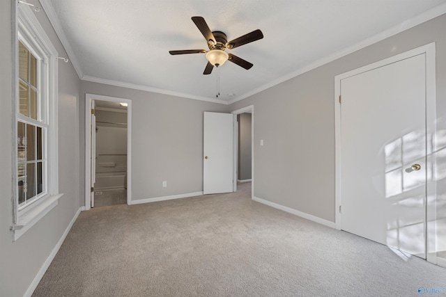 unfurnished bedroom with connected bathroom, crown molding, light colored carpet, and ceiling fan