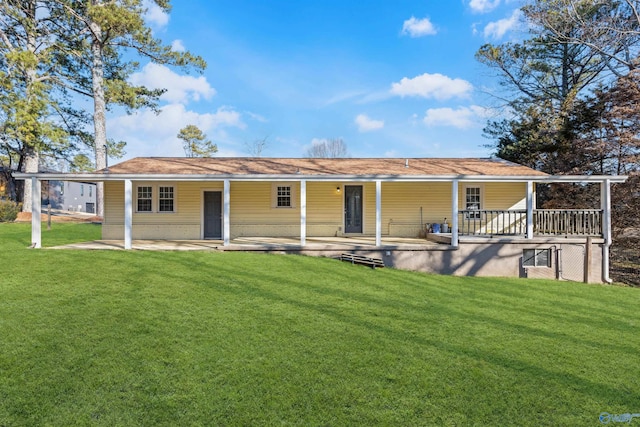 rear view of property featuring a lawn