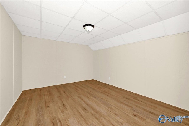 spare room with a drop ceiling and wood finished floors