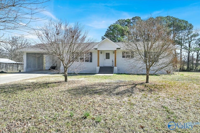 single story home with a carport, a front yard, and driveway