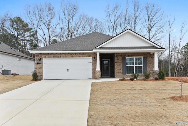 6228 Pisgah Dr NW, Huntsville, AL 35810 - view of front facade with central AC unit, brick siding, a garage, concrete driveway, and roof with shingles