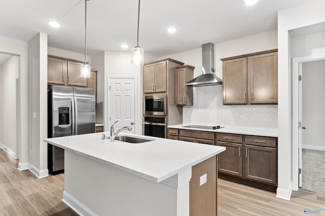 6228 Pisgah Dr NW, Huntsville, AL 35810 - kitchen with wall chimney range hood, a sink, stainless steel appliances, light wood finished floors, and recessed lighting