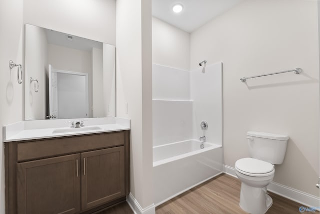 6228 Pisgah Dr NW, Huntsville, AL 35810 - bathroom featuring wood finished floors, toilet, baseboards, vanity, and bathing tub / shower combination
