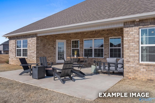 view of patio featuring an outdoor living space with a fire pit