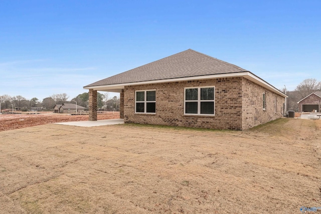 6228 Pisgah Dr NW, Huntsville, AL 35810 - back of property with brick siding, a shingled roof, and central AC