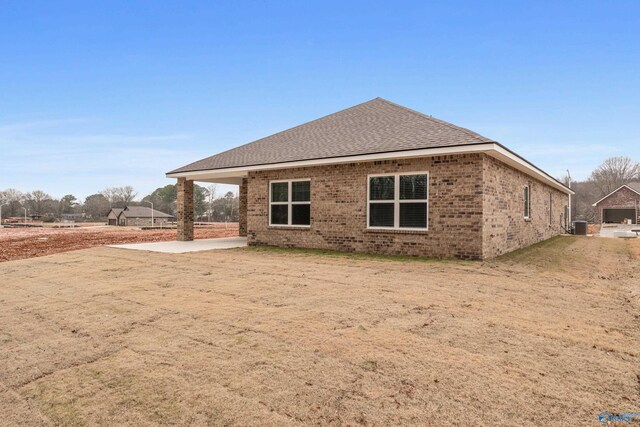 6228 Pisgah Dr NW, Huntsville, AL 35810 - back of property with brick siding, a shingled roof, and central AC