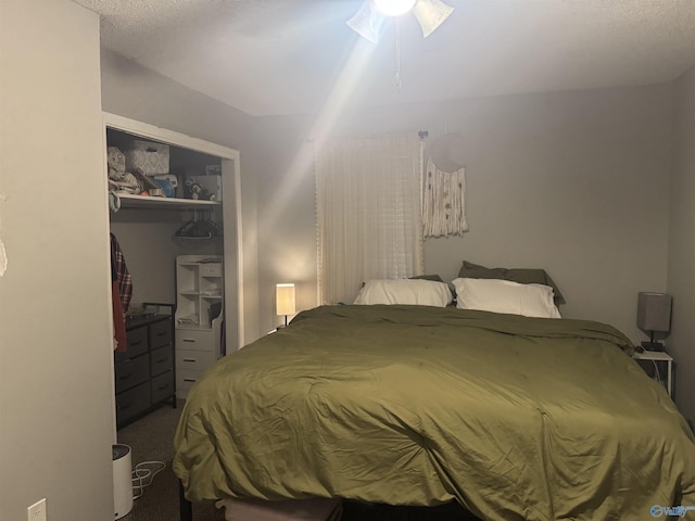 bedroom with ceiling fan, carpet floors, and a closet