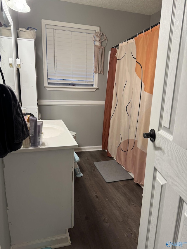 bathroom with vanity, a textured ceiling, and hardwood / wood-style flooring