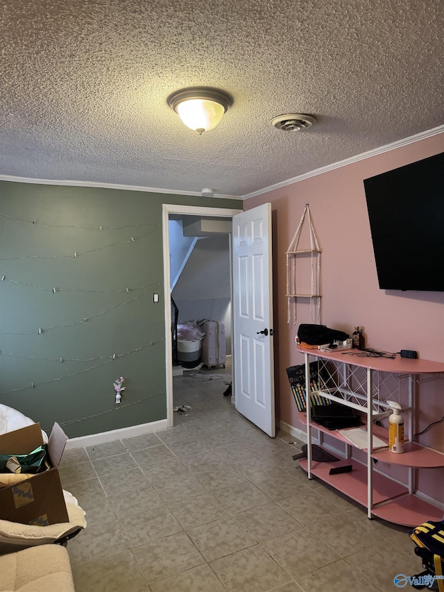 interior space with ornamental molding and a textured ceiling