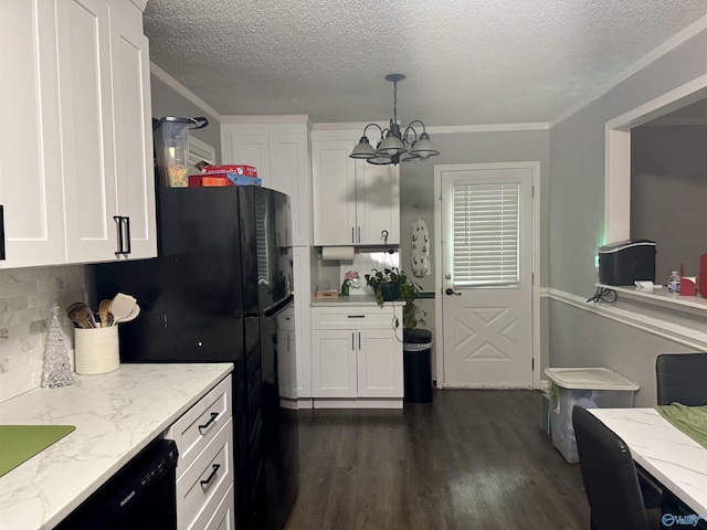 kitchen featuring white cabinets, light stone counters, hanging light fixtures, and dark wood-type flooring