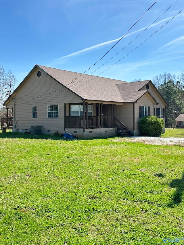 back of house featuring a lawn and central AC unit