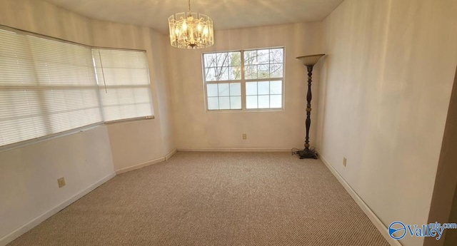 empty room with a chandelier and light colored carpet