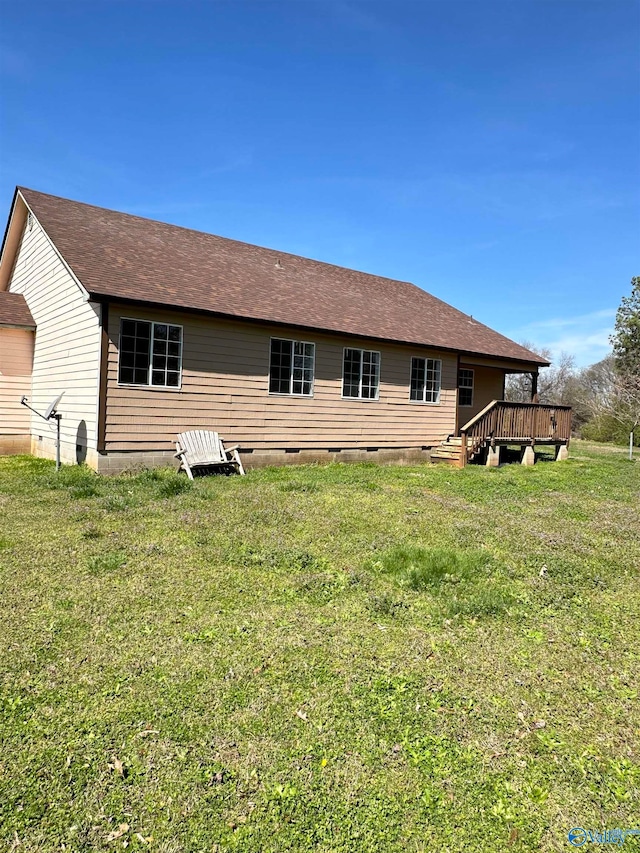 back of house featuring a yard and a wooden deck