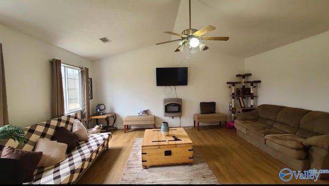 living room featuring hardwood / wood-style floors, vaulted ceiling, and ceiling fan