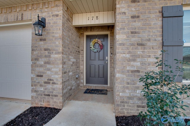 property entrance featuring brick siding