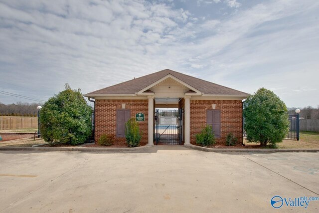 178 Meadow Ridge Dr, Hazel Green, AL 35750 - bungalow-style house with fence, brick siding, and a gate