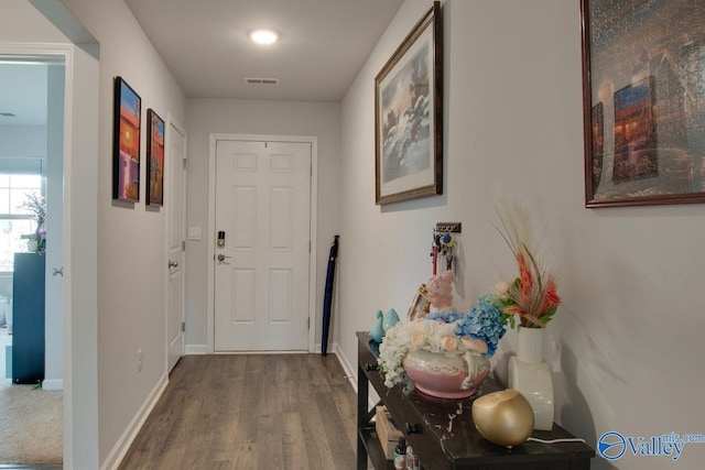 interior space with visible vents, baseboards, and wood finished floors