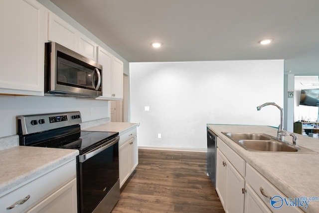 178 Meadow Ridge Dr, Hazel Green, AL 35750 - kitchen with dark wood finished floors, a sink, light countertops, white cabinets, and appliances with stainless steel finishes