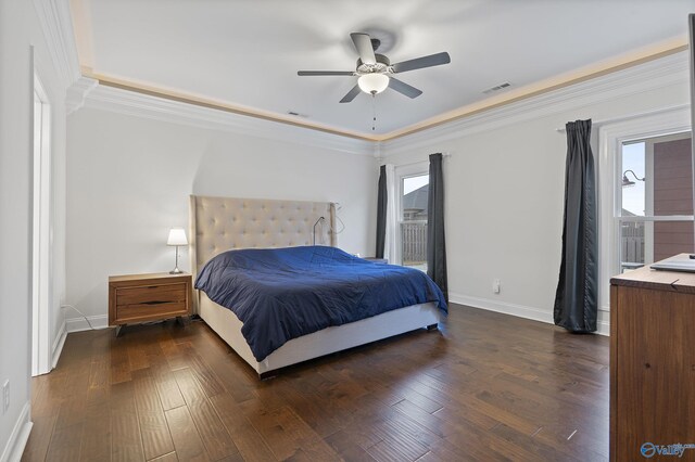 bedroom featuring multiple windows, dark hardwood / wood-style flooring, ceiling fan, and crown molding