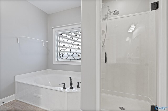 bathroom featuring independent shower and bath and wood-type flooring