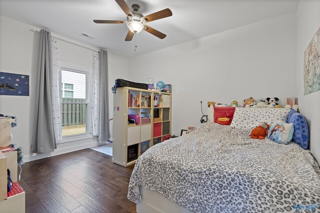 bedroom with ceiling fan and dark hardwood / wood-style flooring