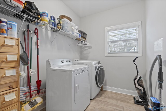 washroom featuring light hardwood / wood-style flooring and washing machine and clothes dryer