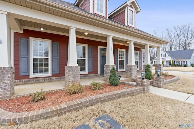 doorway to property featuring covered porch