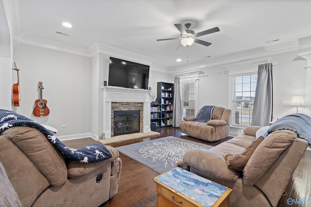 living room with a fireplace, crown molding, ceiling fan, and dark wood-type flooring