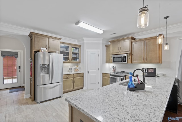 kitchen featuring sink, hanging light fixtures, kitchen peninsula, crown molding, and appliances with stainless steel finishes