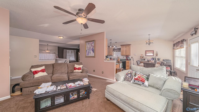 living area with carpet flooring, a textured ceiling, baseboards, and vaulted ceiling