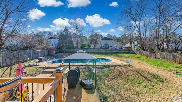 view of yard with a fenced in pool, a fenced backyard, and a patio area