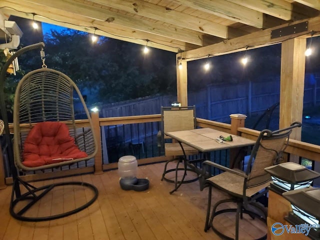 deck featuring outdoor dining area and fence